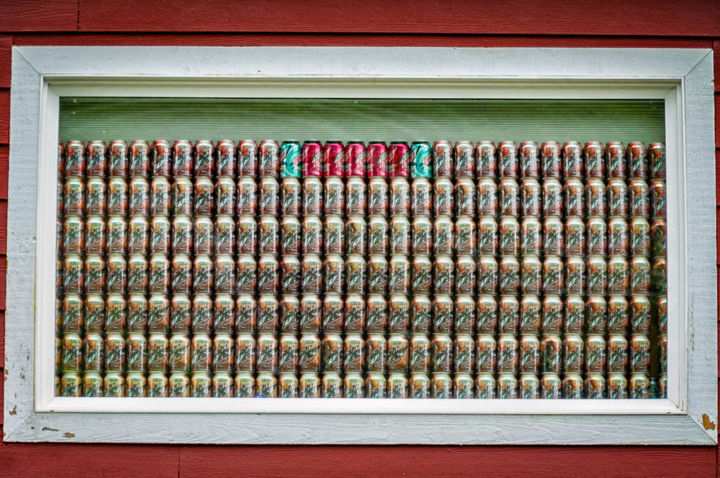 Beer can window covering in Ketchikan