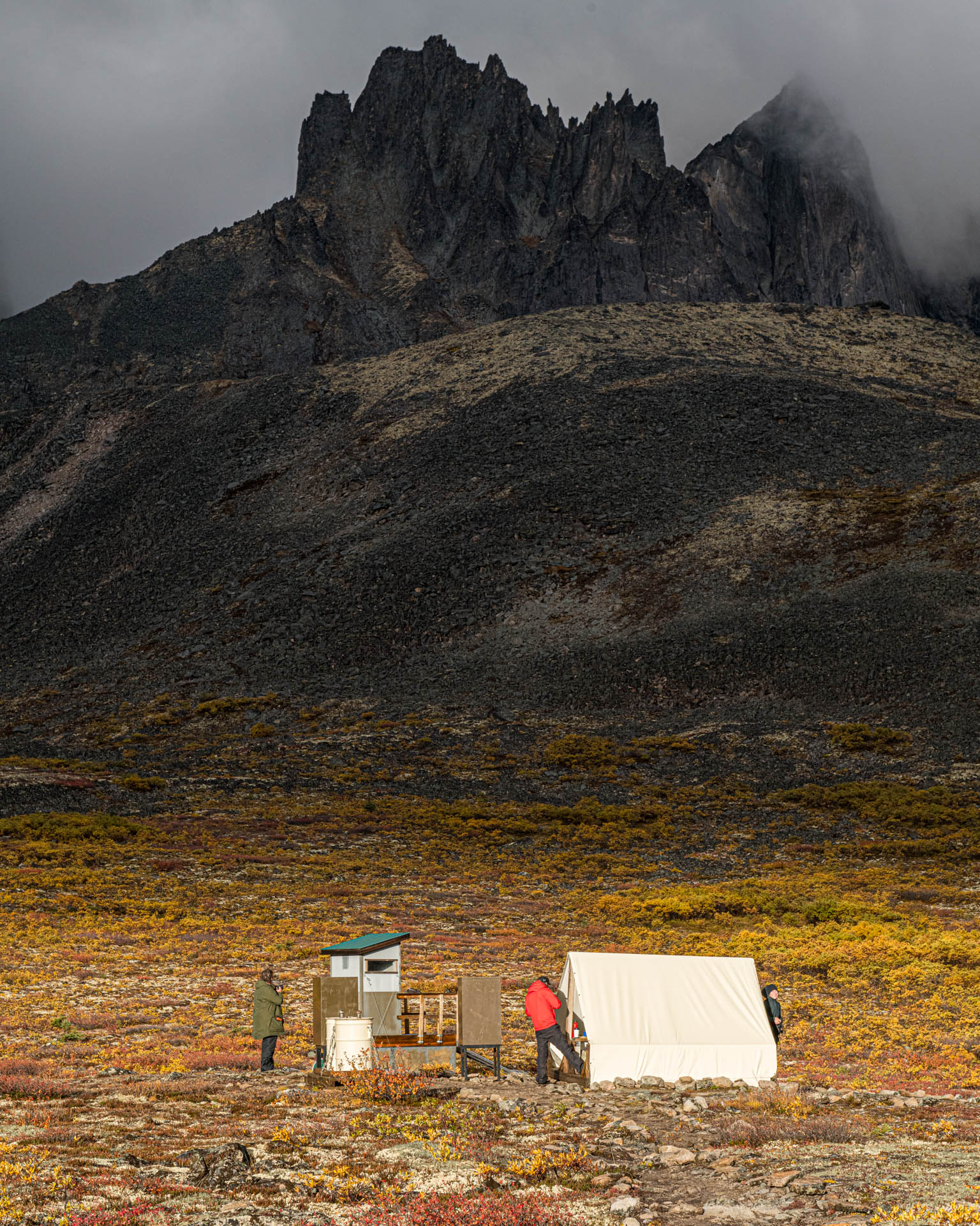 Talus Lake cook tent, bear-proof lockers and outhouse below Mount Monolith