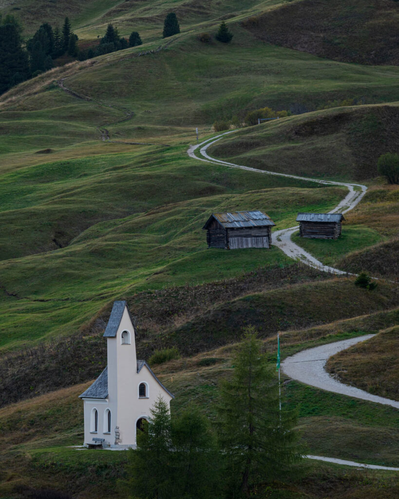 Sunset at Passo Gardena with views of Piz Boè and Sassolungo (church in foreground)