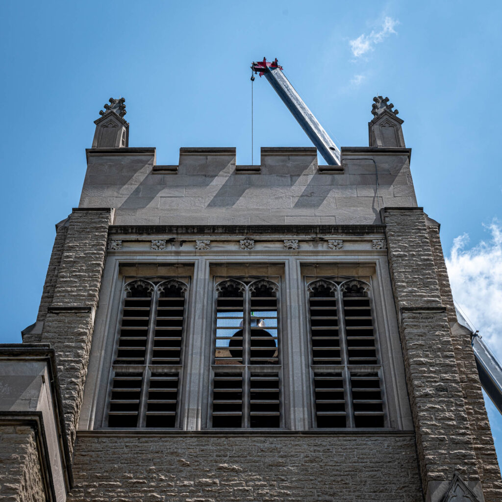 Lowering the new bell into the tower